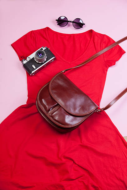 istock Camera, bag, dress and sunglasses on pink background. 511950253
