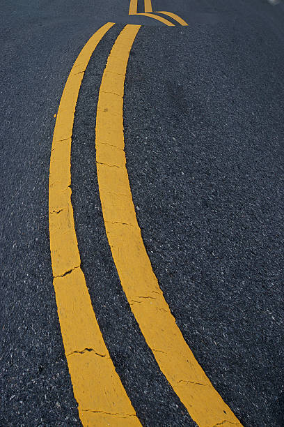 istock Two yellow traffic lines. on thr road. 511951397