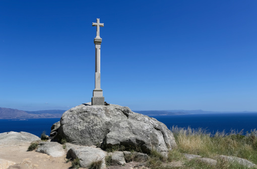Stone cross at the lighthouse of Cape Finisterre, the final destination for many pilgrims on the Way of St James to Compostela. It is located at the Costa da Morte in Galicia, Spain. In Roman times it was considered to be the end of the known world.