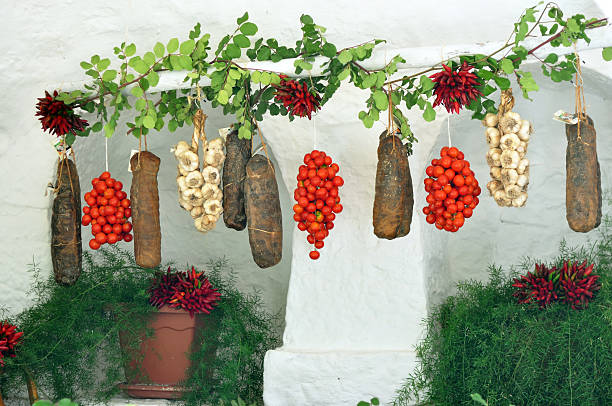 Capocollo Italian tomatoes and chilli Tomatoes chilli and capocollo in typical house of Puglia trulli house photos stock pictures, royalty-free photos & images