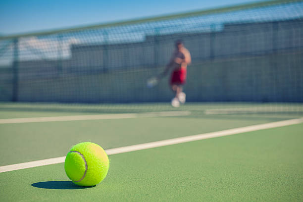 istock tennis ball on court with copy space 511972469