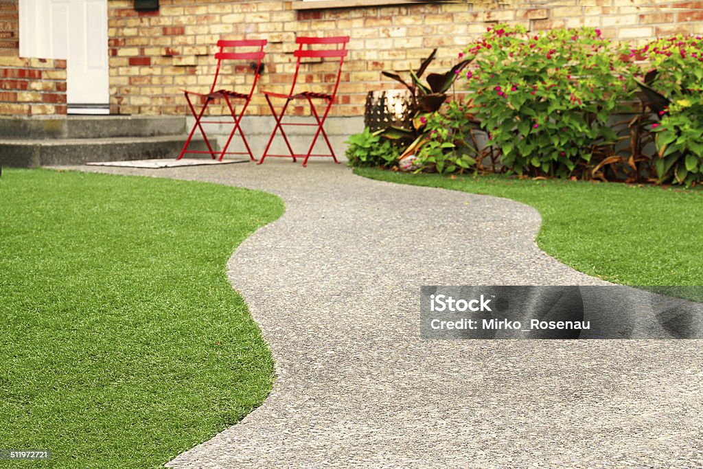 Walk way with perfect grass landscaping with artificial grass in residential area Artificial Stock Photo