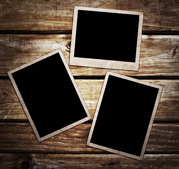 istock Aged photo frames on wood background 511972793