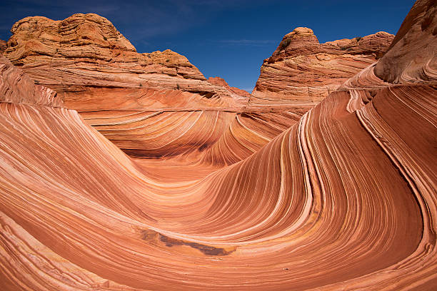 Coyote Buttes North - The Wave The Wave is located in the Coyote Buttes North area of the Arizona Strip and is a multi-colored chute that has been cut into a sandstone mountain. the wave arizona stock pictures, royalty-free photos & images