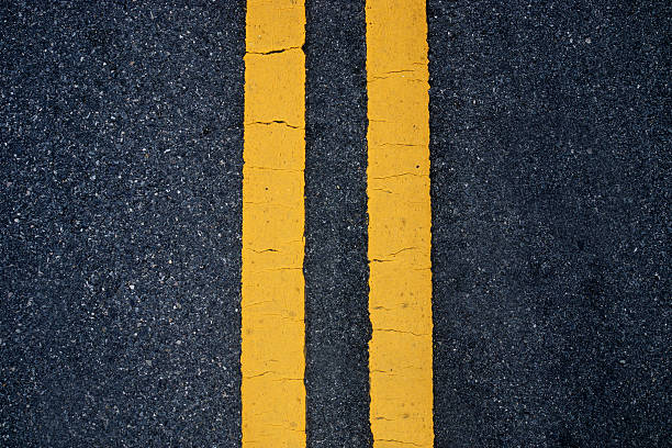 istock Two yellow traffic lines. on thr road. 511973351