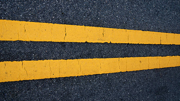istock Two yellow traffic lines. on thr road. 511973505