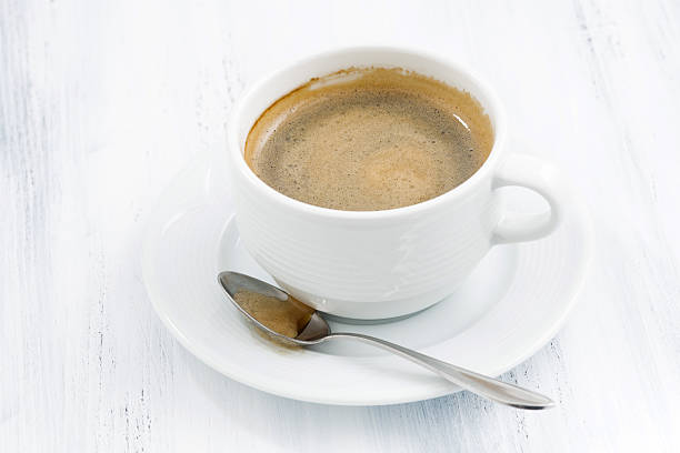 istock cup of black coffee on white wooden table 511976538