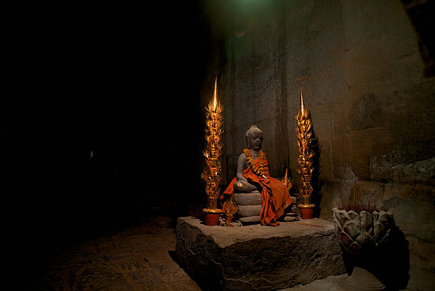 Buddha statue in a temple in Cambodia covered with a Golden color cloth