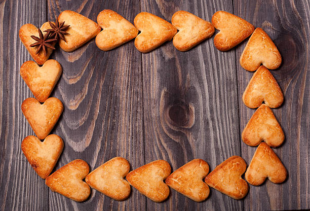 istock frame from heart shaped cookies on wooden table 511976760