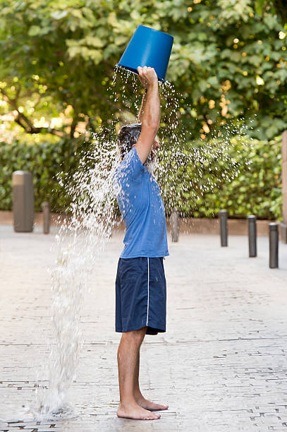 istock man pouring ice bucket on internet viral media campaign 511976963
