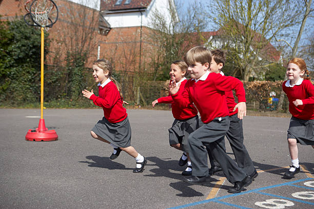 istock Group Of Elementary School Pupils Running In Playground 511977117