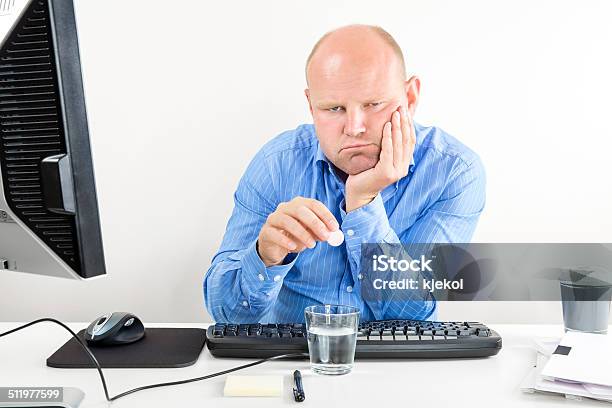 Overworked Office Worker Taking Pills For Headache Stock Photo - Download Image Now - Adult, Adults Only, Blue