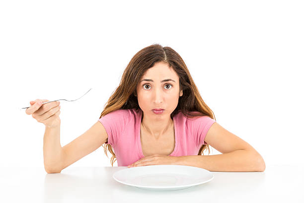 istock Woman on diet with an empty plate 511977810