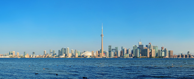 Toronto skyline panorama over lake with urban architecture.