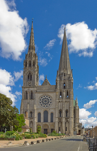 Facade of Chartres Cathedral, France in summer with road leading to it