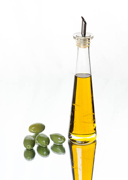 istock Green olives and crystal olive oil bottle 511984576