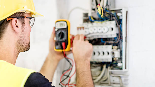 Electrician testing for voltage in a fuse box Individual testing the voltage of a circuit breaker at a fuse box. electrician multimeter stock pictures, royalty-free photos & images