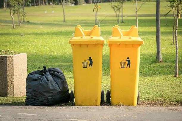 Garbage bags placed beside the bins.