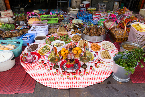 Bangkok, Thailand - February 6, 2016: Chinese New Year religious offerings in a house located on Yaowarat Road in the in Samphanthawong district which is home to Bangkok's Chinatown. The offering of food serves to bring ancestors and other beings in the other world closer to oneself.