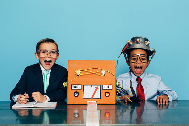 istock Two Young Businessman with Lie Detector 511990834
