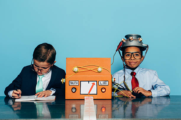 istock Two Young Businessman with Lie Detector 511990862