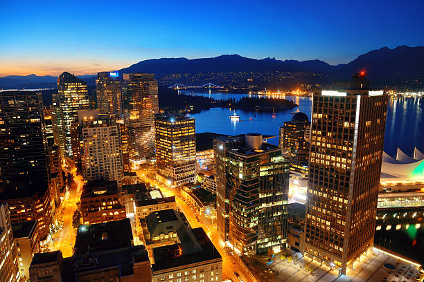 Vancouver rooftop view Vancouver rooftop view with urban architectures at dusk. vancouver at night stock pictures, royalty-free photos & images