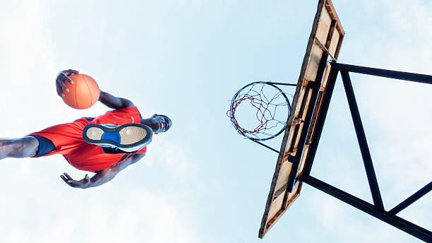 istock Young man jumping to score in basketball 511995006