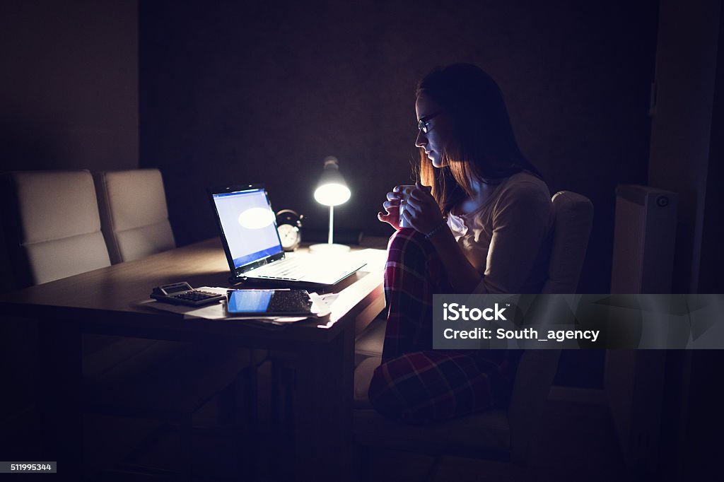 Tired Woman working at home,making a break Scene of a exhausted young business woman working late at night to meet an urgent deadline. Domestic Life Stock Photo