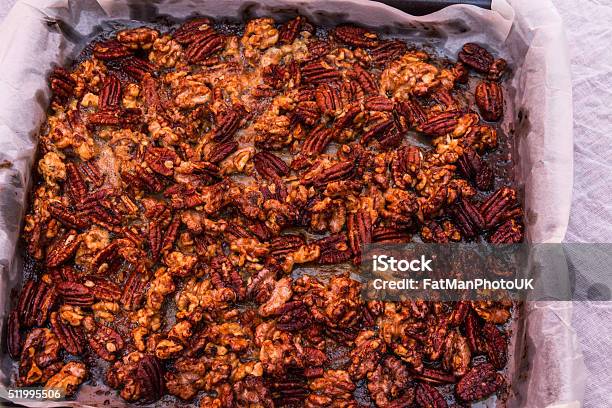 Mixed Garlic And Rosemary Roasted Nuts Cooked And Cooling Stock Photo - Download Image Now