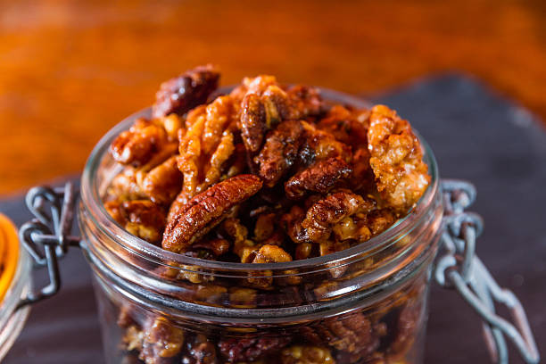 istock Bowl with mixed garlic and rosemary roasted nuts, macro. 511996046