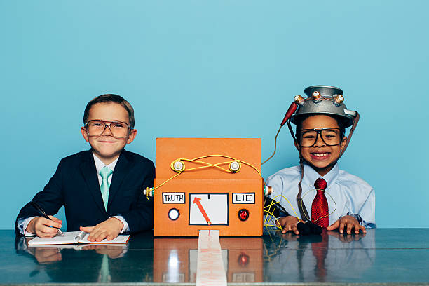 Young Honest Businessman is Tested with Lie Detector Two young boys and businessman in business attire and glasses sit at an office desk with a homemade lie detector machine. One businessman has an excited expression in front of a blue wall as the other asks questions. You can never get too much practice for a job interview. nerd kid stock pictures, royalty-free photos & images