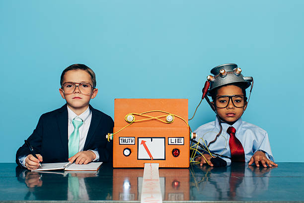 istock Young Honest Businessman is Tested with Lie Detector 511996102