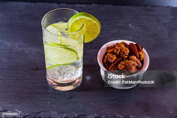 Gin And Tonic With Bowl Of Mixed Roast Nuts Stock Photo - Download Image Now - Alcohol - Drink, Aperitif, Bar - Drink Establishment