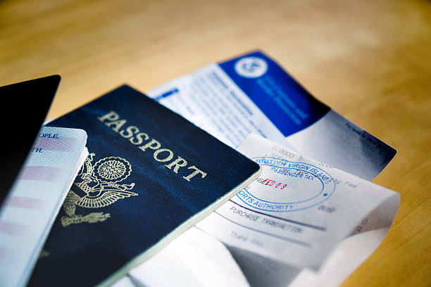 Passports and Visa Two American passports with visa or tourist cards tucked inside all stamped and ready to go.g department of homeland security stock pictures, royalty-free photos & images