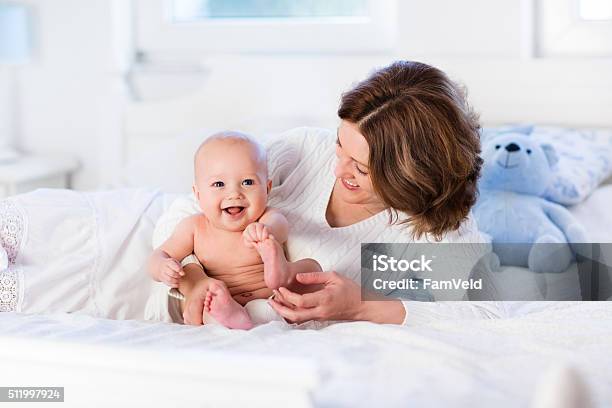 Adorable Mother And Baby On A White Bed Stock Photo - Download Image Now - Baby - Human Age, New Life, Parent