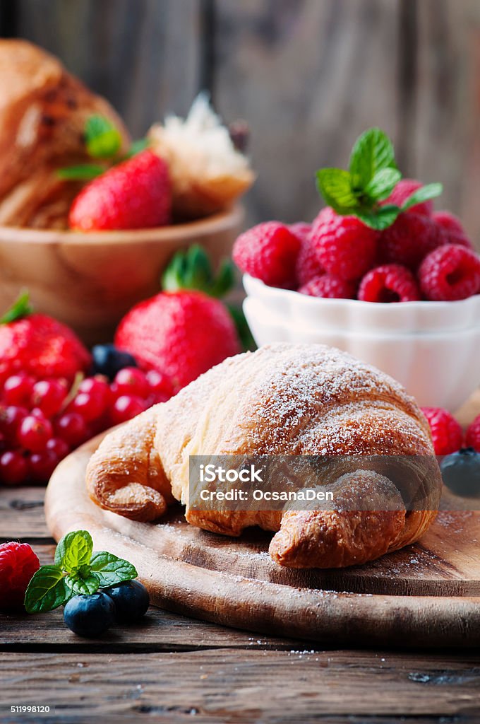 Fresh croissant with mix of berry Fresh croissant with mix of berry, selective focus Backgrounds Stock Photo