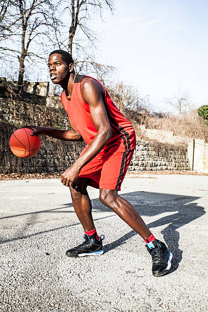 istock Young basketball player dribbling 511999592