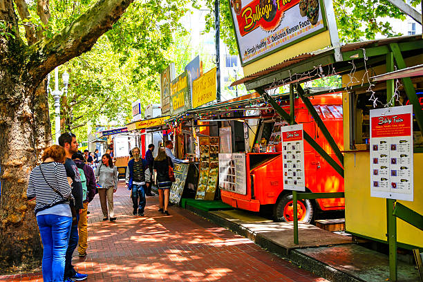 Multi-ethnic fast-food vendors in downtown Portland, Oregon Portland, OR, USA - July 16, 2015: People ordering food from the multi-ethnic fast-food vendors in downtown Portland, Oregon portland oregon photos stock pictures, royalty-free photos & images