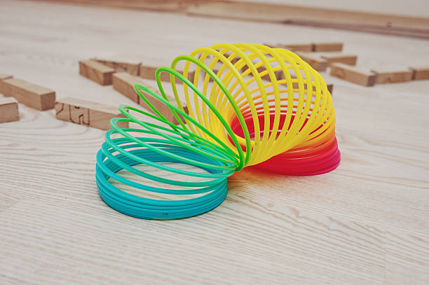 istock Rainbow spiral spring game on wooden background 512001310