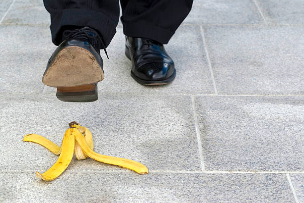 istock Businessman stepping on banana skin, copy space 512001652