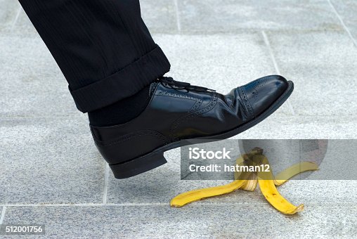 istock Businessman stepping on banana skin 512001756