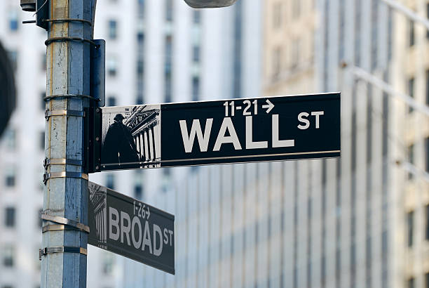 New York City Wall Street New York City Wall Street road sign in downtown Manhattan with skyscrapers. wall street lower manhattan stock pictures, royalty-free photos & images