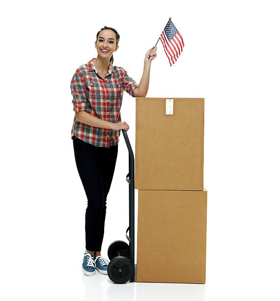istock Smiling woman holding box and American flag 512005956