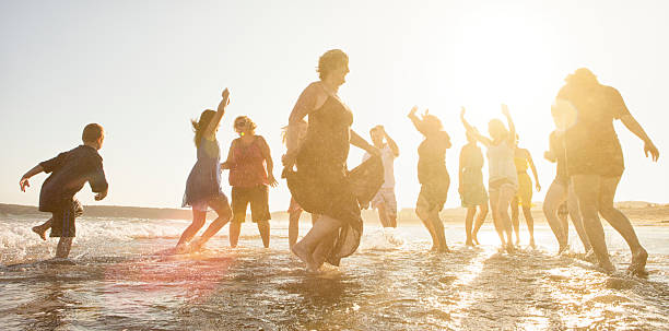 istock Group of people running on the beach 512009929
