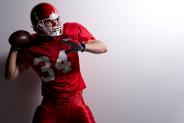 istock American football player throwing a ball 512010053