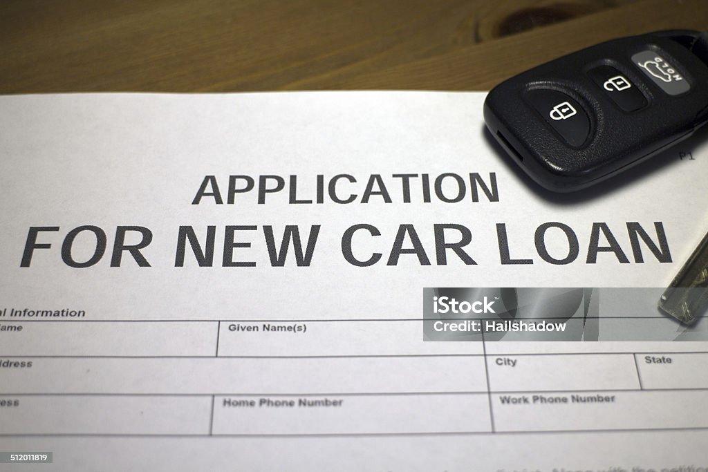 Vehicle loan Someone filling out an application for new car loan. Agreement Stock Photo