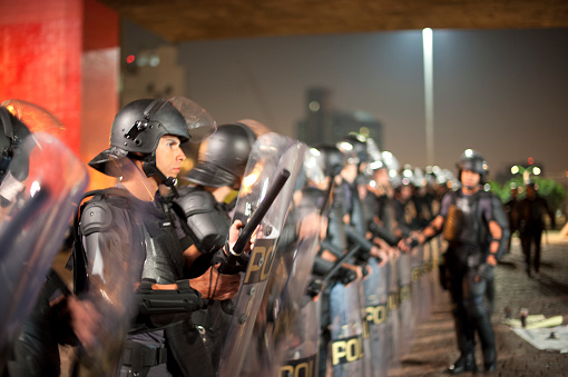 São Paulo, Brazil, July, 21, 2014: Police officers in riot gear during act on Paulista Avenue for the release of political prisoners detained during demonstrations in the city