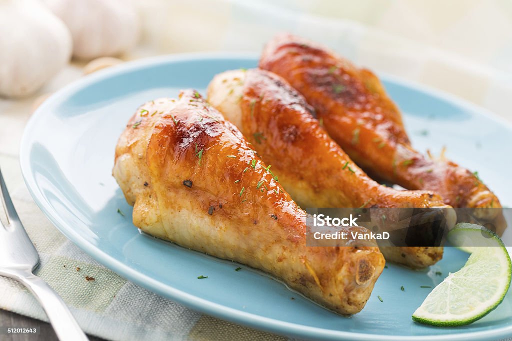 Roasted chicken legs Delicious roasted chicken legs on a plate Animal Body Part Stock Photo