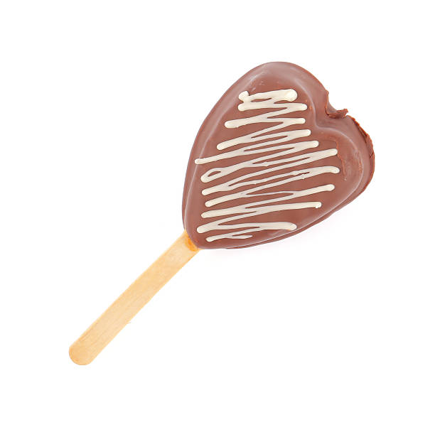 istock Heart souffle bread piece covered with chocolate on wooden stick 512015635