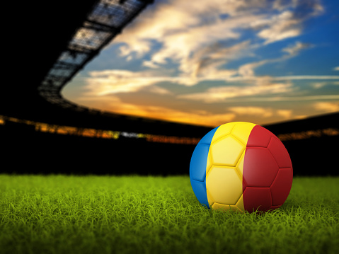 Soccer Stadium Background with Ball, Romania Flag. High detailed 3D of Soccer ball with national flag and grass against stadium